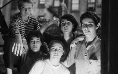 Photo en noir et blanc représentant cinq femmes regardant l'objectif